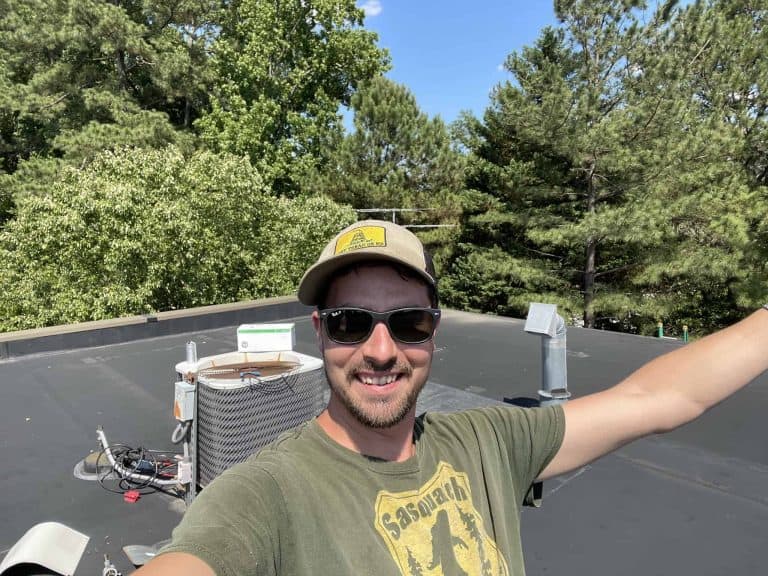 HVAC technician installing or maintaining equipment on a building roof in North Carolina.