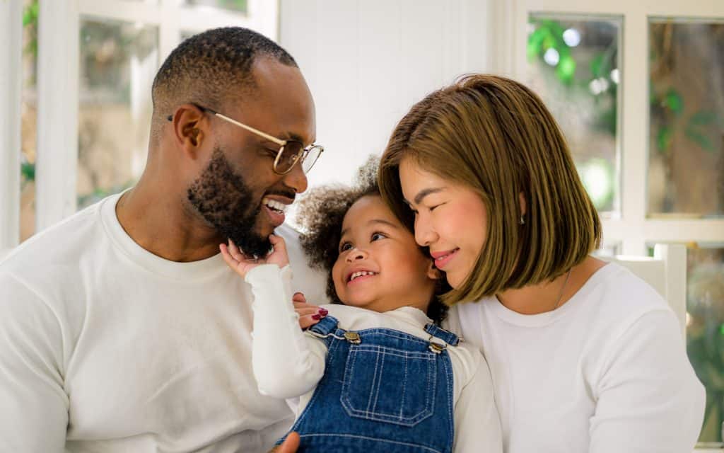 Portrait of happy family father mother and daughter spending vacation